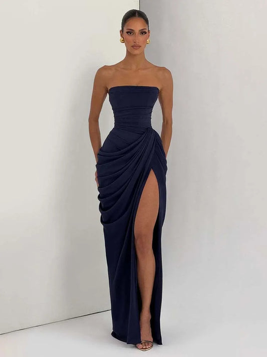 Navy strapless gown with a high slit on a white background