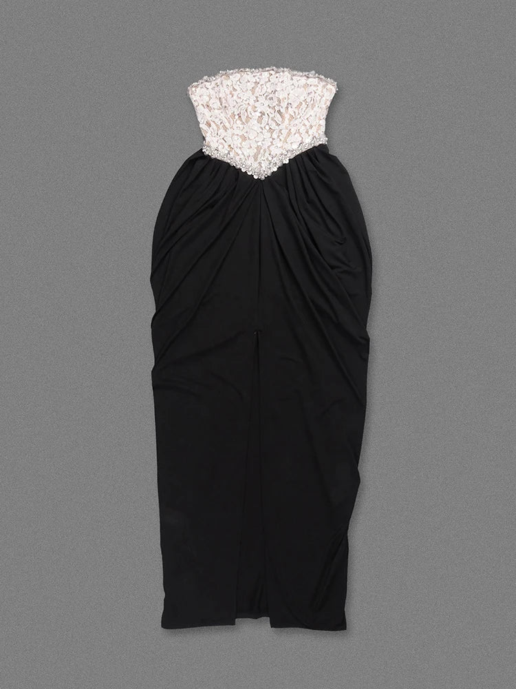 Black strapless dress with lace top on a gray background
