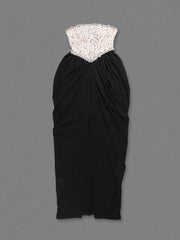 Black strapless dress with lace top on a gray background