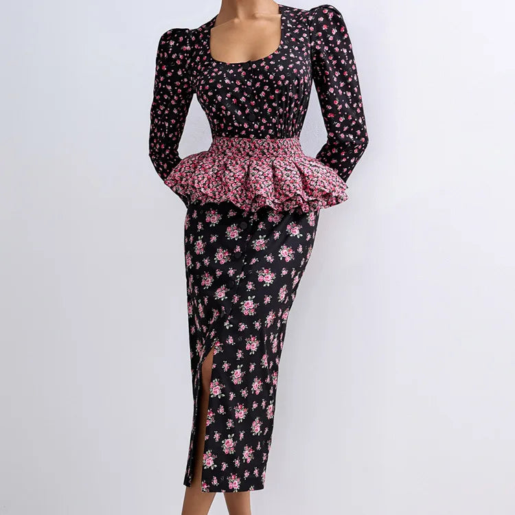 Black floral dress with pink peplum and skirt on a white background