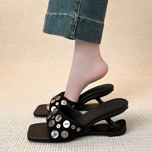 Square toe wedge heel slide sandal with decorative shell buttons, shown on a foot.