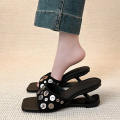 Square toe wedge heel slide sandal with decorative shell buttons, shown on a foot.