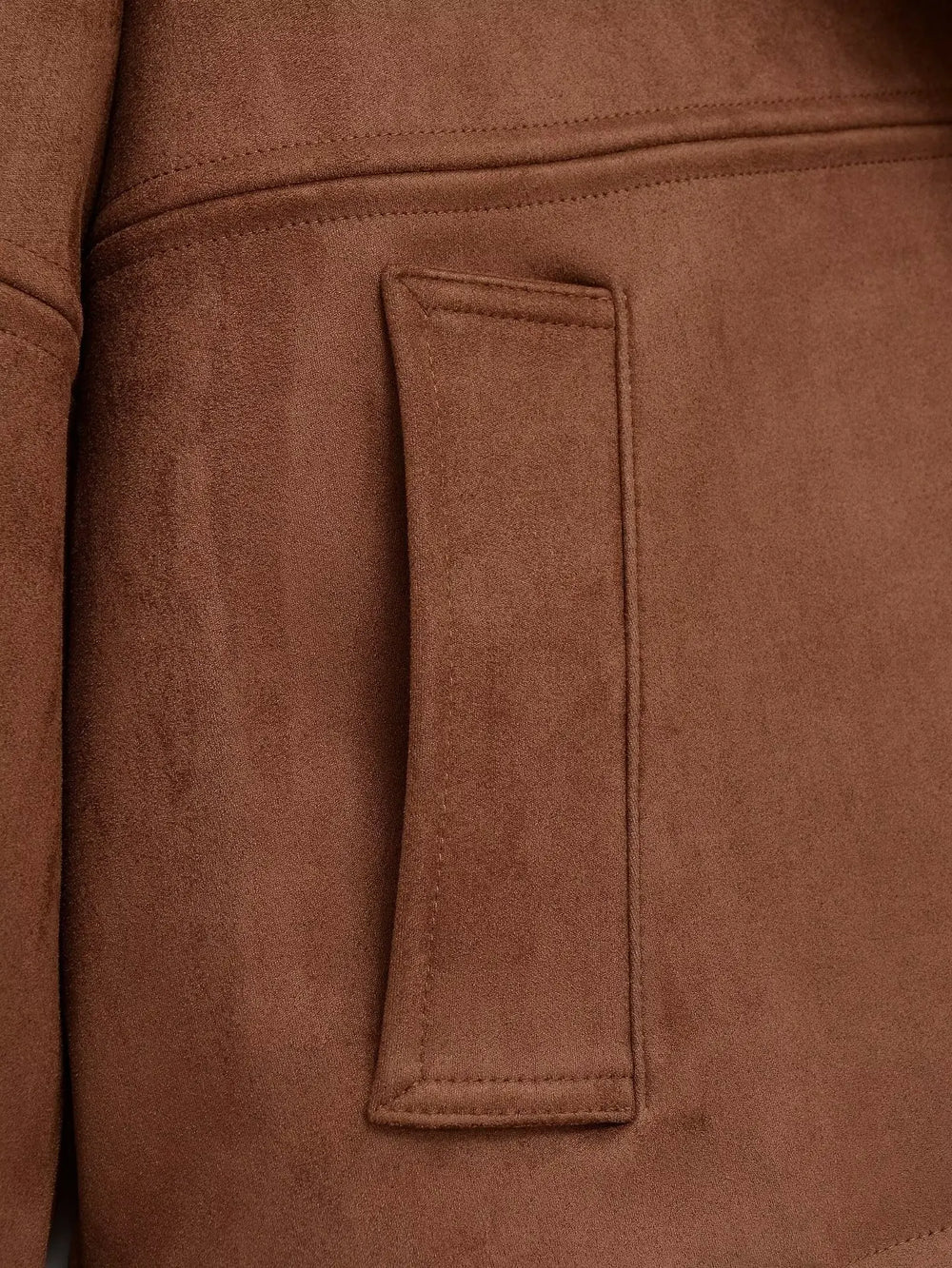 Detail of pocket on faux suede jacket