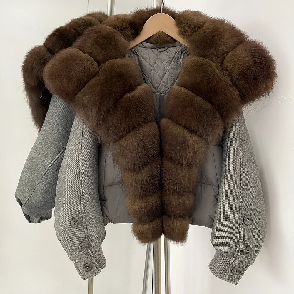 Gray jacket with brown fur trim on a hanger against a white background
