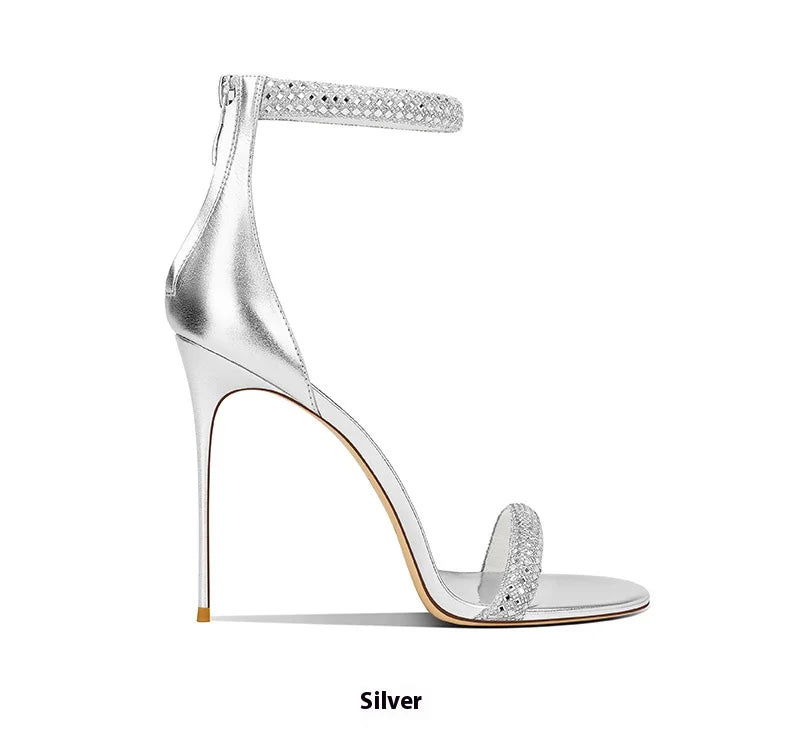Silver high-heeled sandal with clear heel on a white background