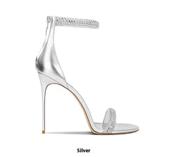 Silver high-heeled sandal with clear heel on a white background