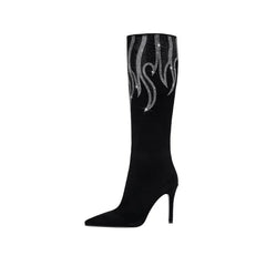 Black knee-high boot with silver flame design on a white background