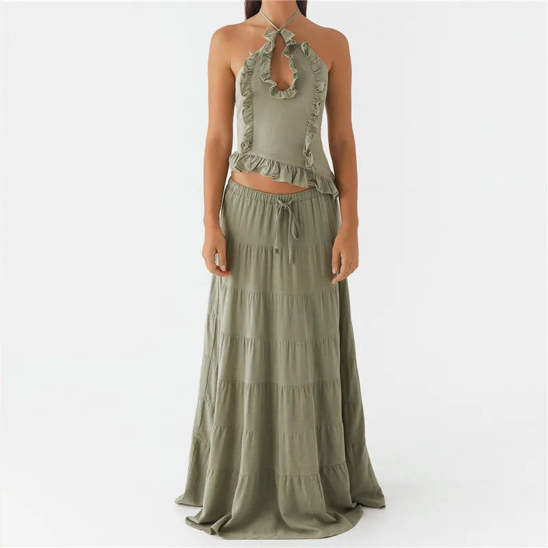 Green two-piece outfit with a halter top and tiered skirt on a white background