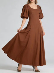 Brown dress with puff sleeves on a white background