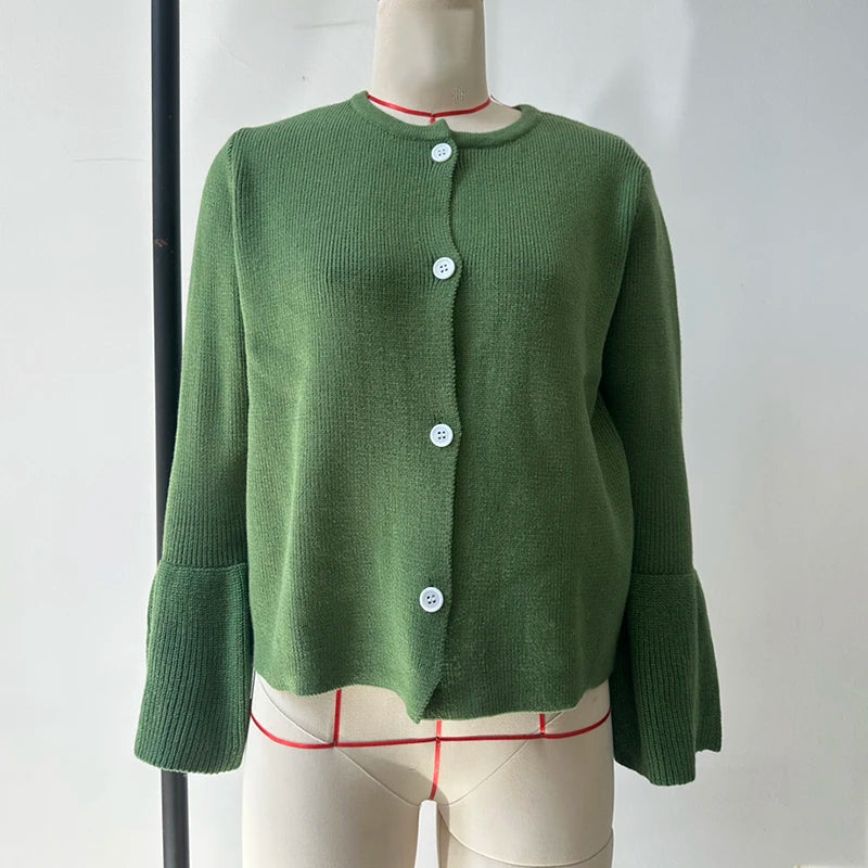 Green cardigan on a mannequin against a white background