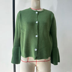 Green cardigan on a mannequin against a white background