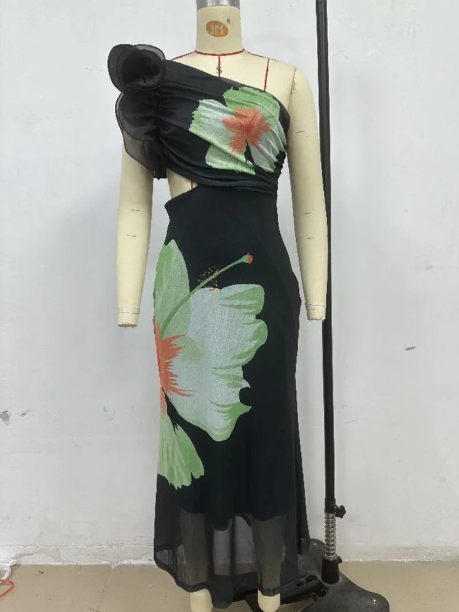 Black dress with floral patterns on a mannequin against a white background