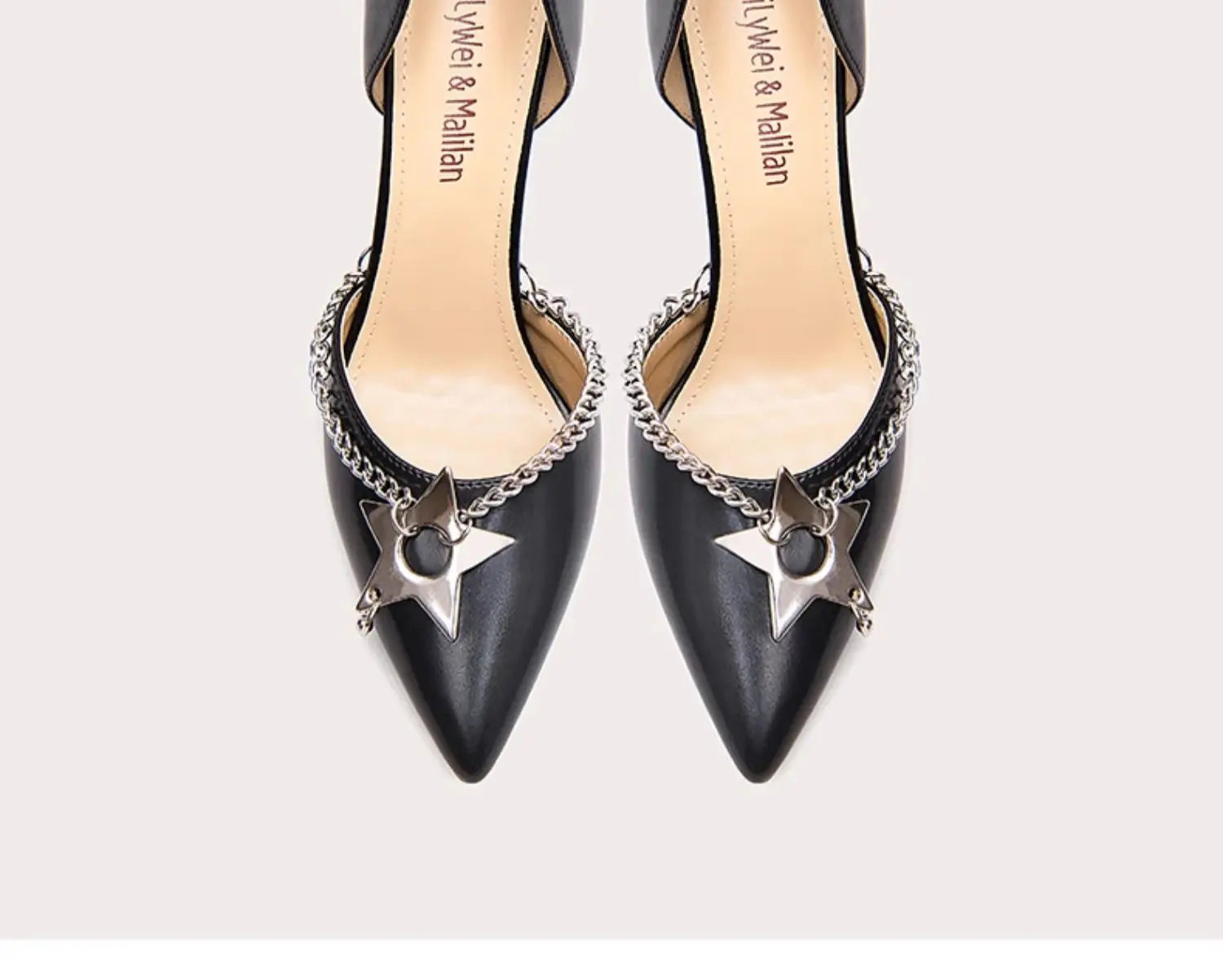 Black high-heeled shoes with star and chain details on a white background