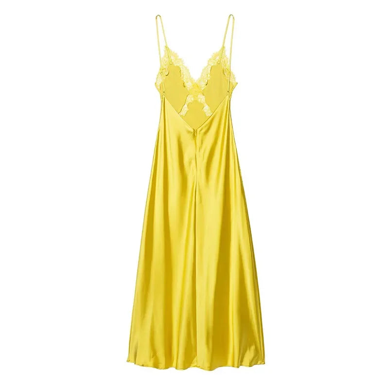 Yellow satin slip dress on a white background