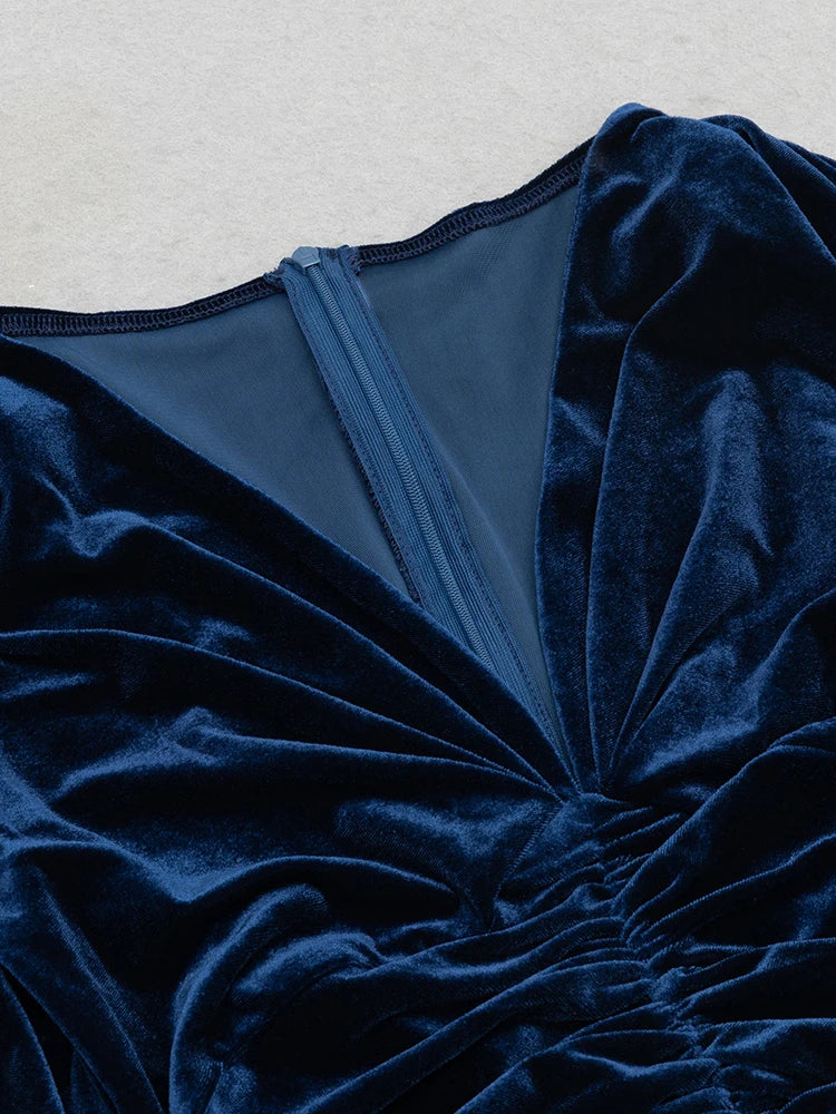 Close-up of a blue velvet garment with a textured surface.