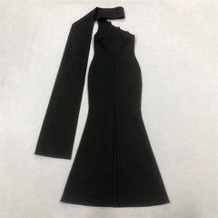 Black one-shoulder dress with a bow detail on a white background