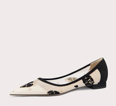 Black and white flat shoe on a light gray background