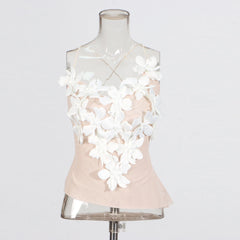 Mannequin wearing a light pink top with white floral embellishments on a white background