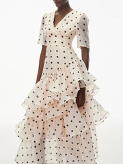 Close-up of the tiered ruffle detail on a polka dot maxi dress
