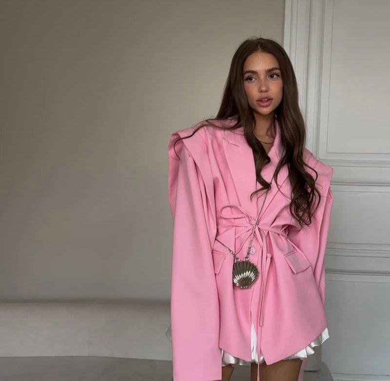 Woman wearing a pink coat in an indoor setting