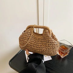 Woven handbag on a table with a glass of tea