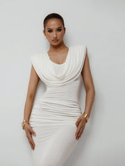 Woman wearing a white dress against a plain background