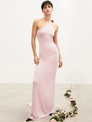 Woman wearing a pink strapless gown with a white background