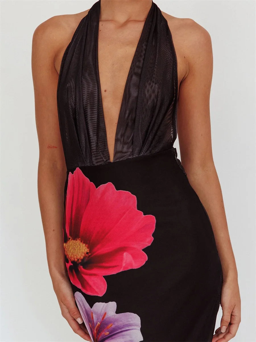 Black halter neck dress with floral design on a plain background
