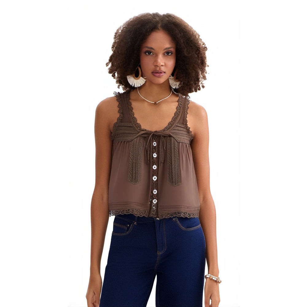 Woman wearing a brown lace top and blue jeans on a white background