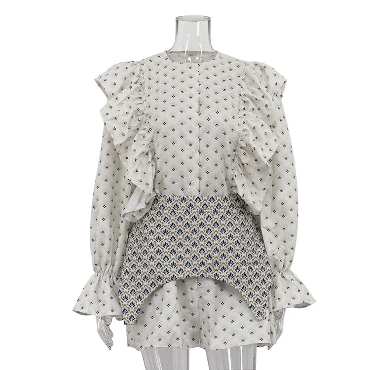 Mannequin wearing a layered outfit with a white top and patterned skirt on a white background