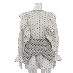 Mannequin wearing a layered outfit with a white top and patterned skirt on a white background