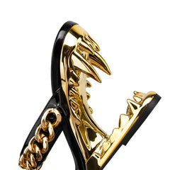 Gold and black high-heeled shoes with wing-like design on a white background