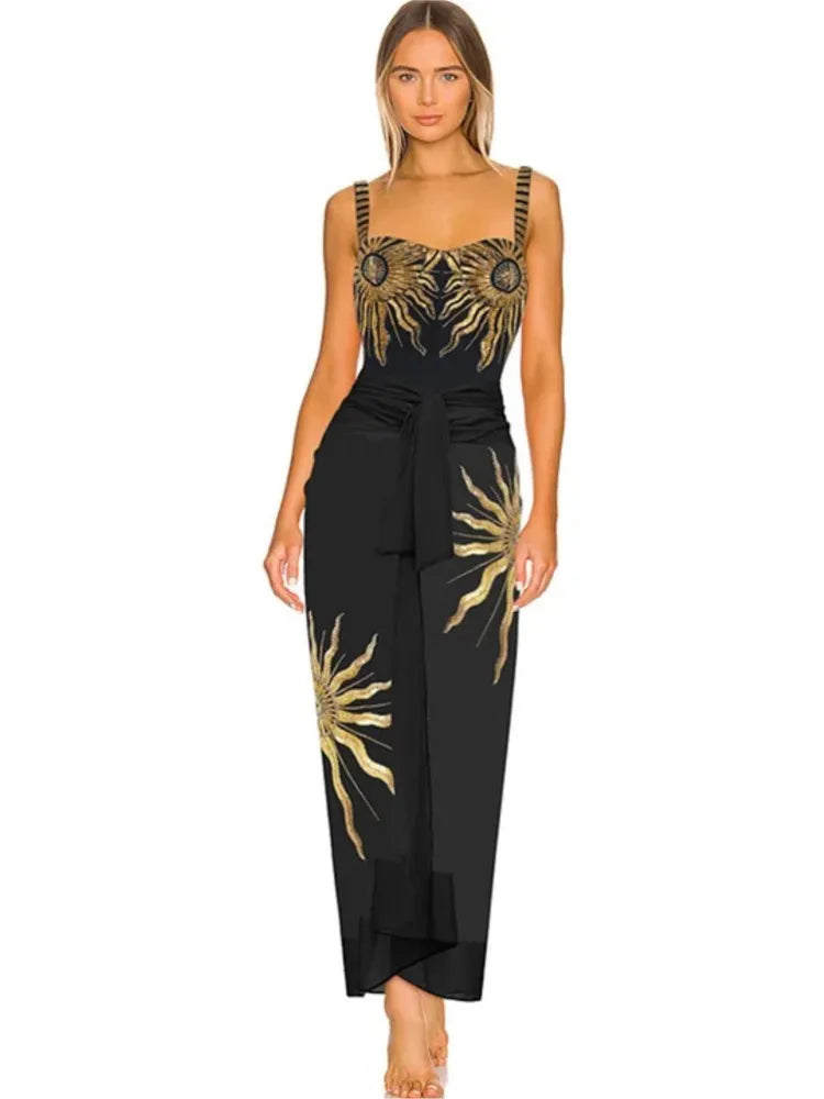 Black swimwear set with gold sunburst embellishments and matching belted skirt