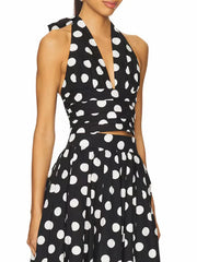 Polka dot two-piece summer outfit featuring halter crop and high-waist skirt.