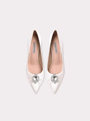 White pointed-toe shoes with crystal embellishments on a white background