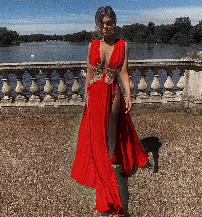 Woman in a red dress standing outdoors with a scenic background
