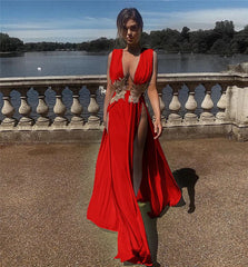 Woman in a red dress standing outdoors with a scenic background