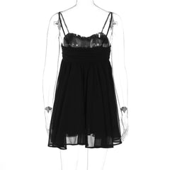 Black dress on a mannequin with sheer overlay against a white background