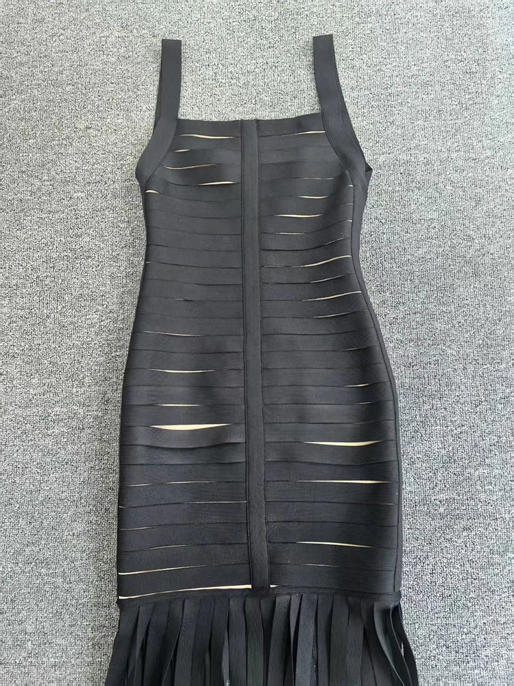 Black dress with cut-out design on a gray textured background