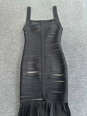 Black dress with cut-out design on a gray textured background