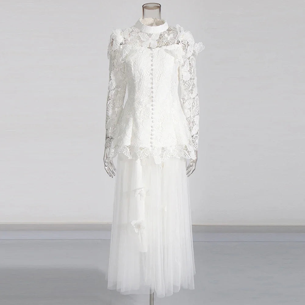 White lace dress on a mannequin against a plain background