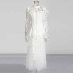 White lace dress on a mannequin against a plain background