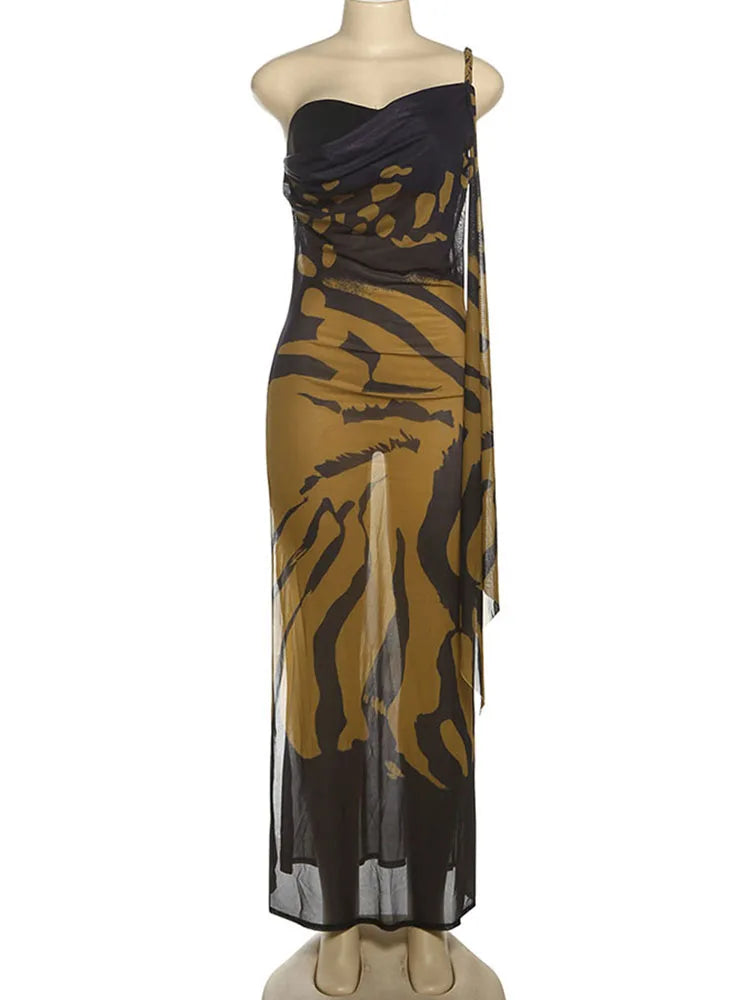 Mannequin wearing a black and gold patterned dress on a white background