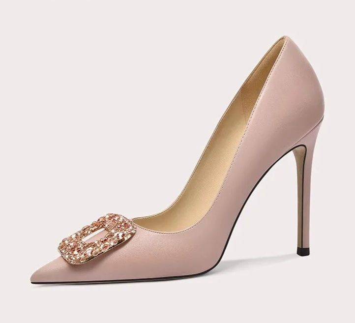 High-heeled shoe with decorative buckle on a white background