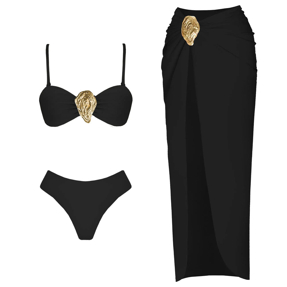 Model wearing a black halter neck bikini top and high-slit wrap skirt