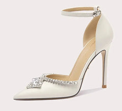 White high-heeled shoe with decorative element on a white background