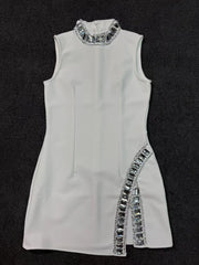 White dress with silver embellishments on a black background