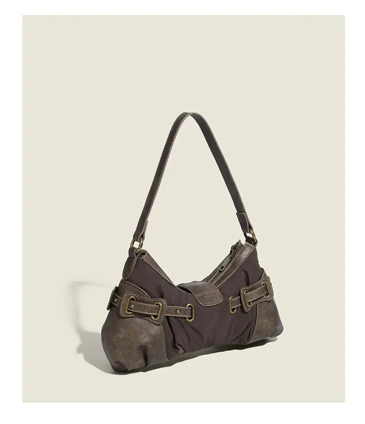 Brown handbag with leather straps on a beige background