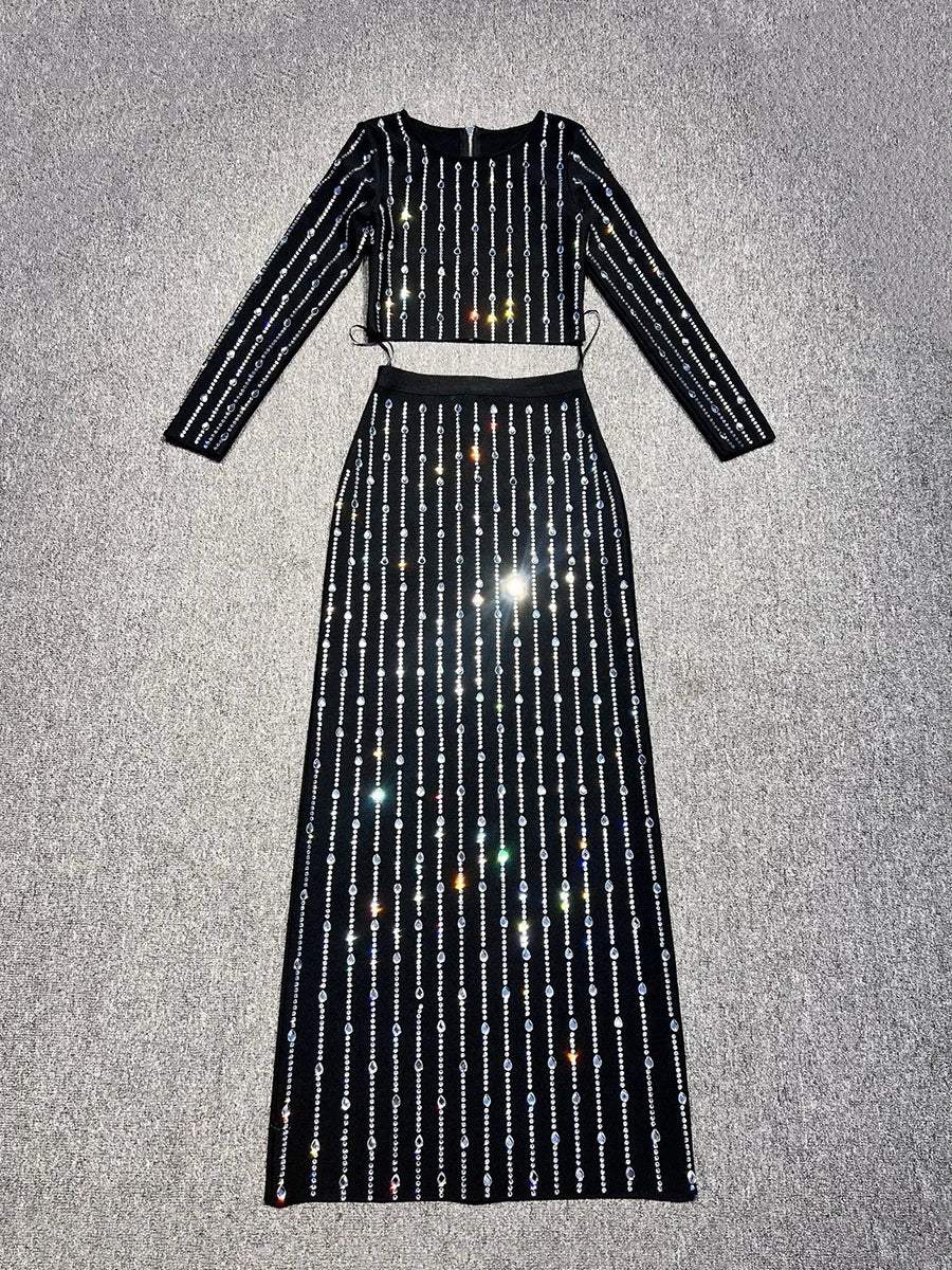 Black sequin two-piece outfit on a textured gray background