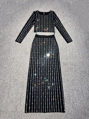 Black sequin two-piece outfit on a textured gray background